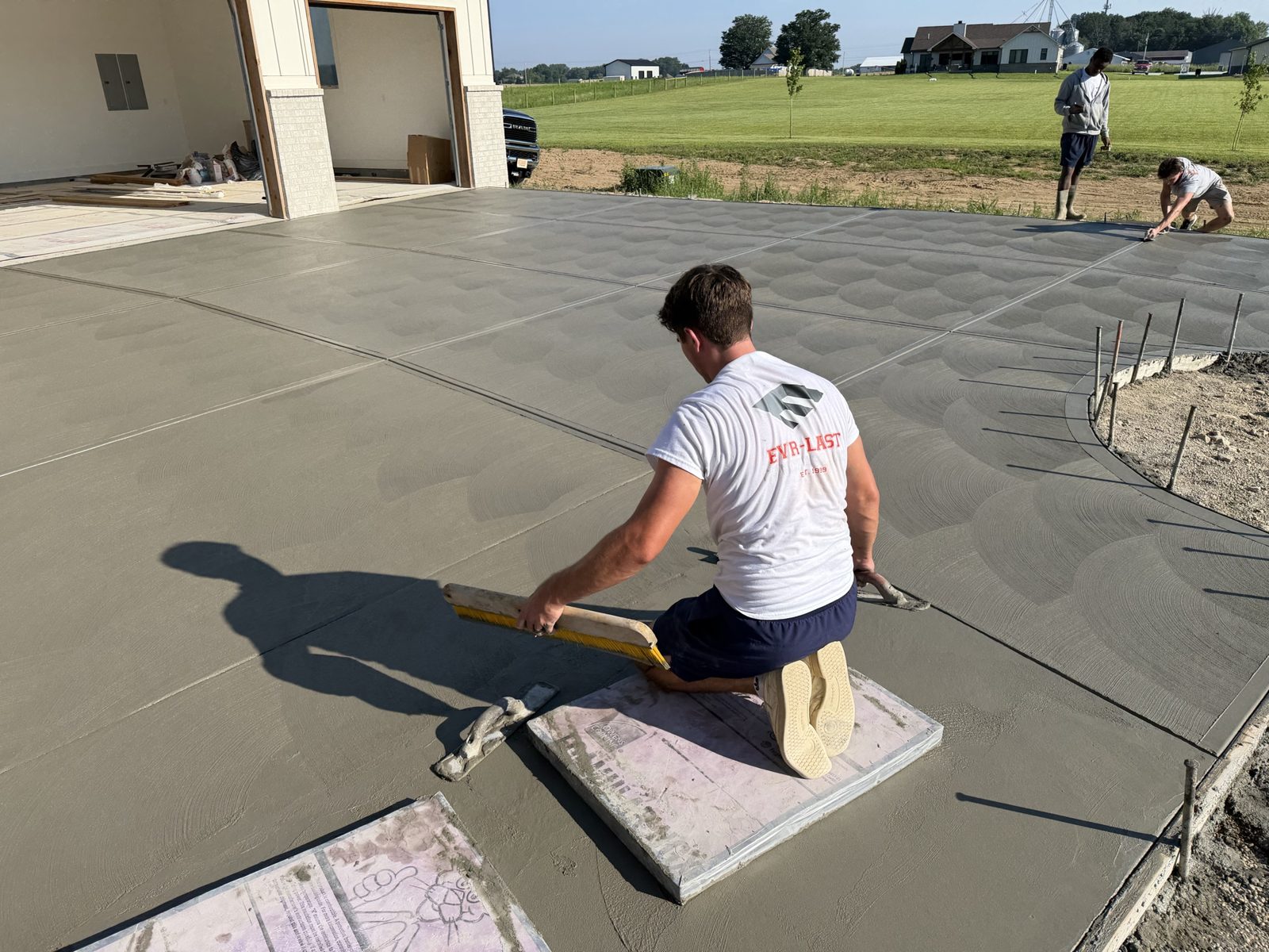 EVR-LAST crew member broom-finishing a fresh concrete pour
