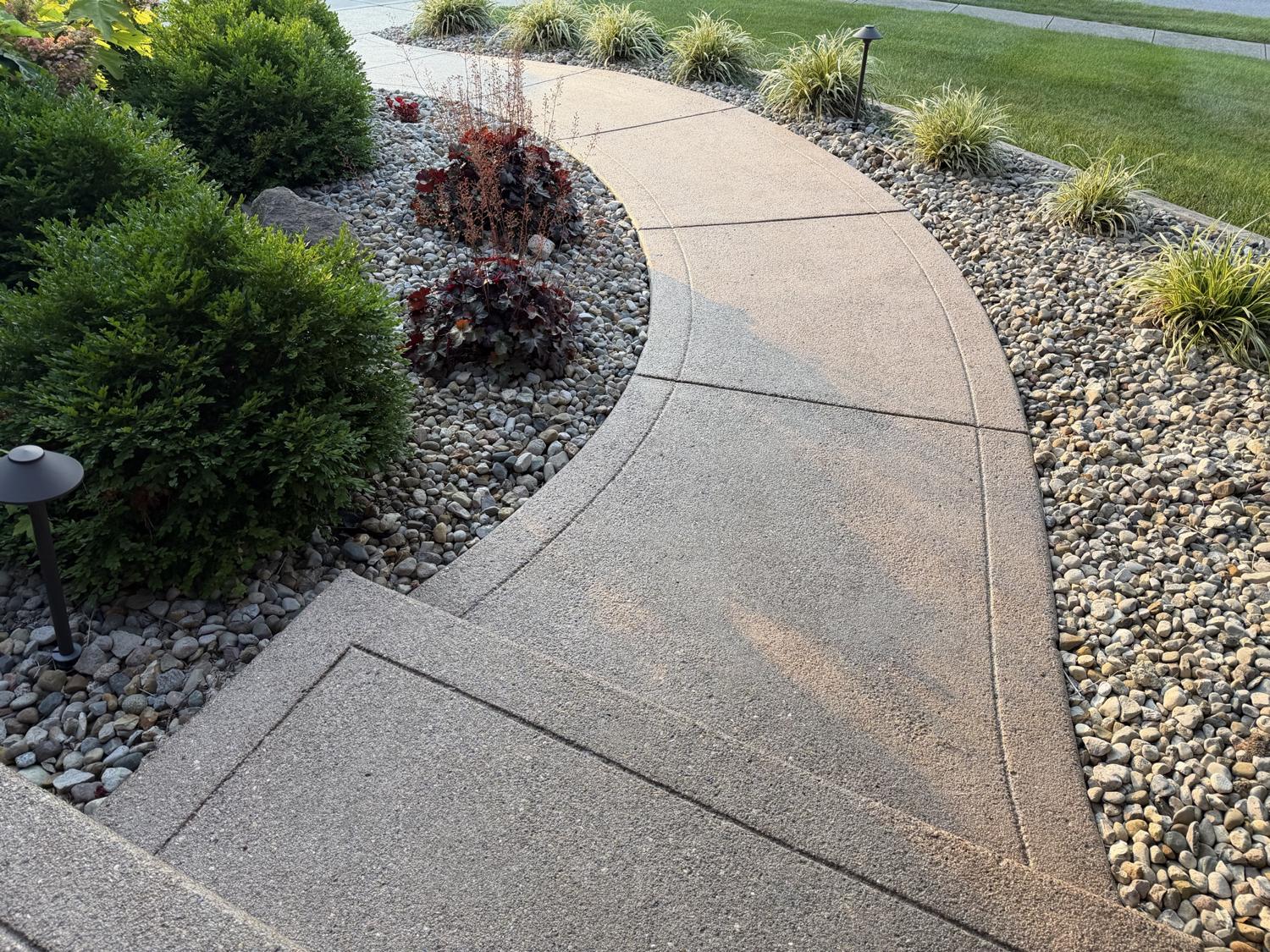 Decorative concrete walkway with tooled border and textured finish